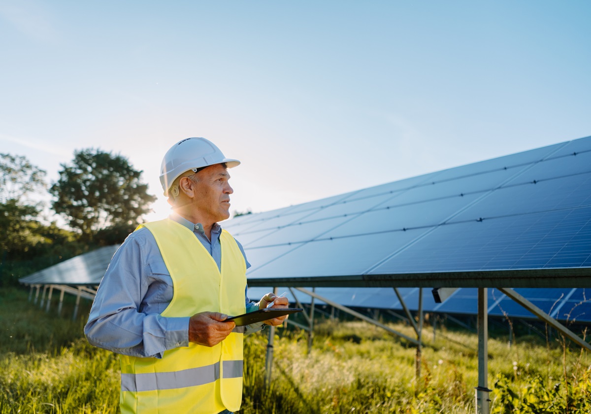 Environmental manager inspecting solar panels