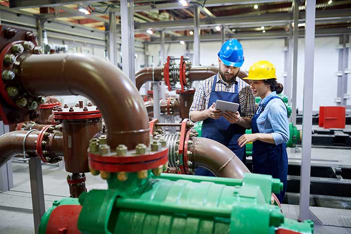 Technicians inspect water purification system