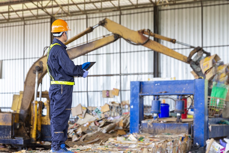 Engineer and loader inside a recycling plant