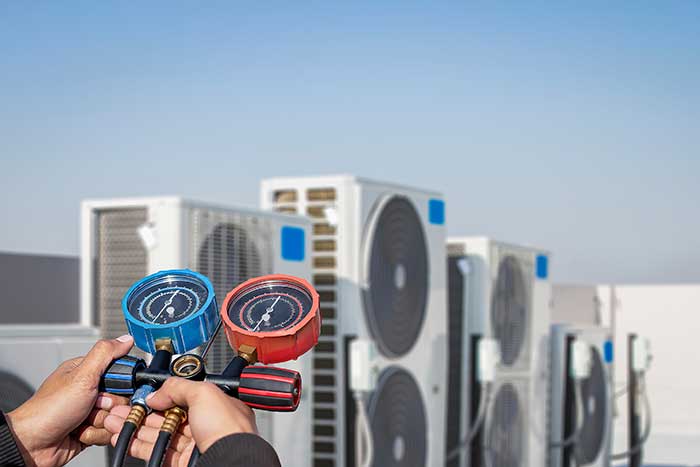 Air conditioner technician checking air conditioner operation