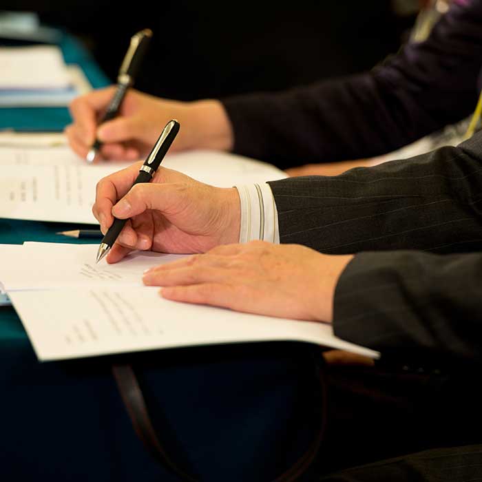 People taking notes at a workshop