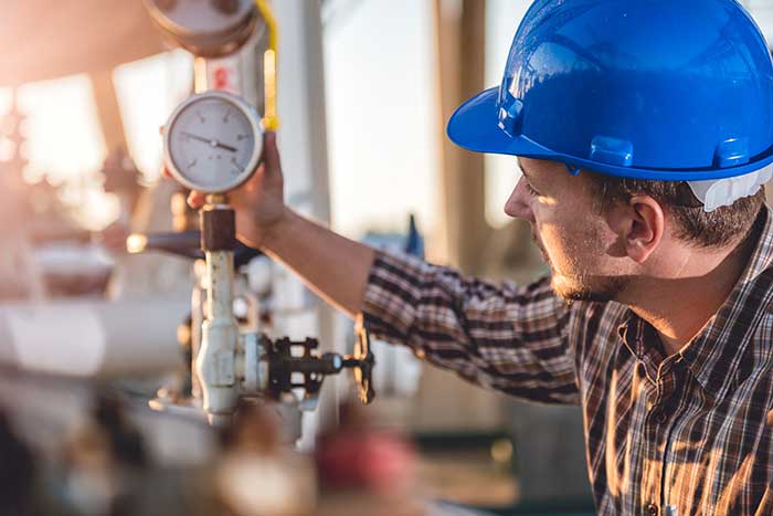 Technician checking manometer